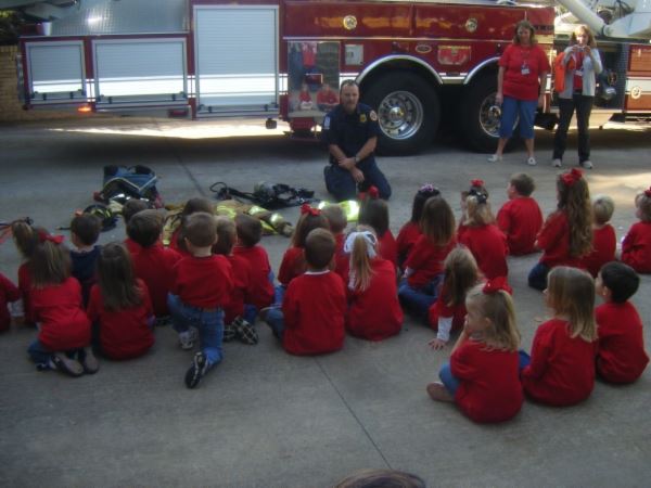 Children Sitting down at a Fire Department