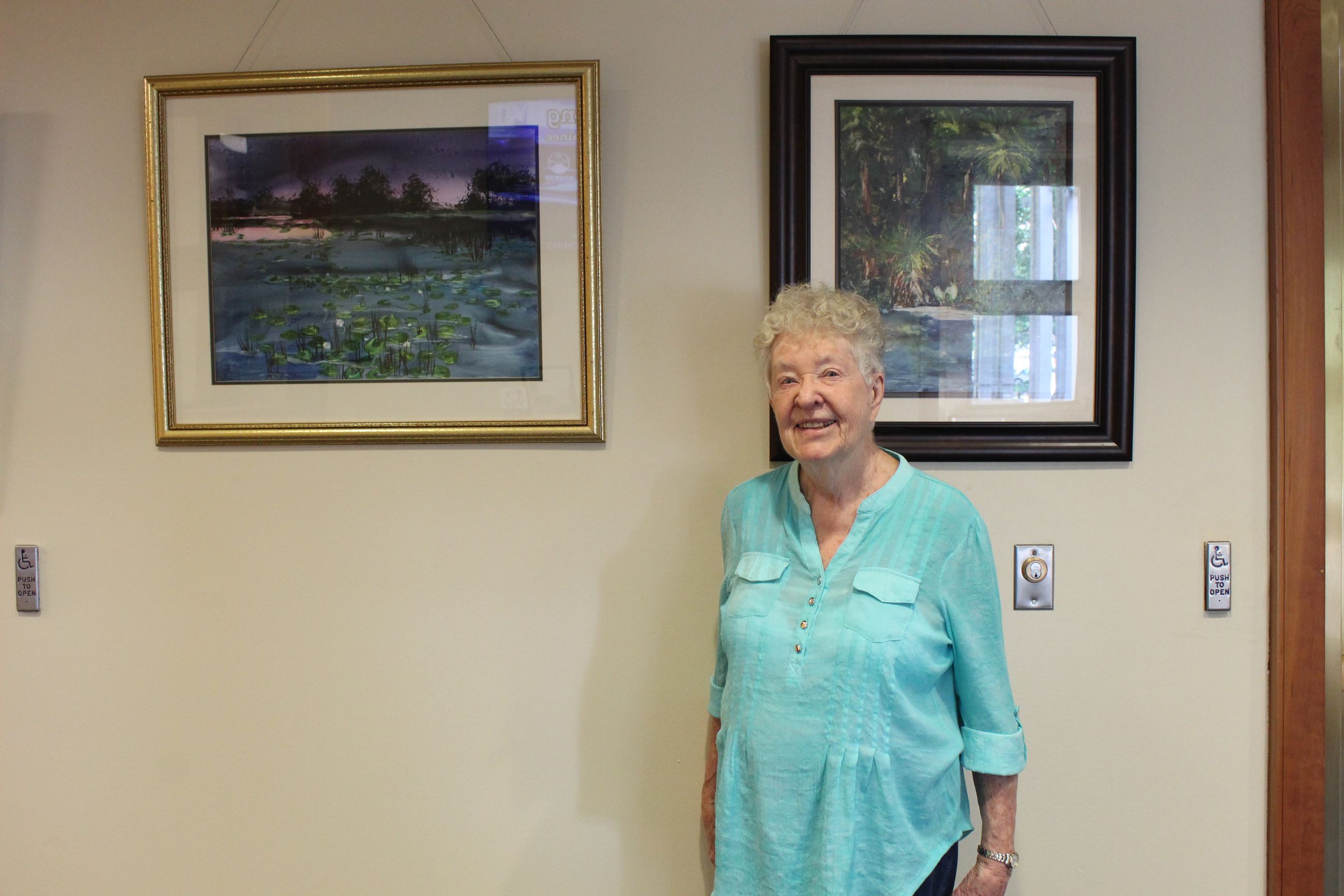 Cornelia Craine in the City Hall lobby with her artwork